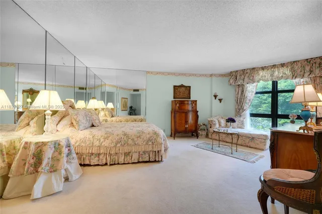 a living room with furniture and a refrigerator