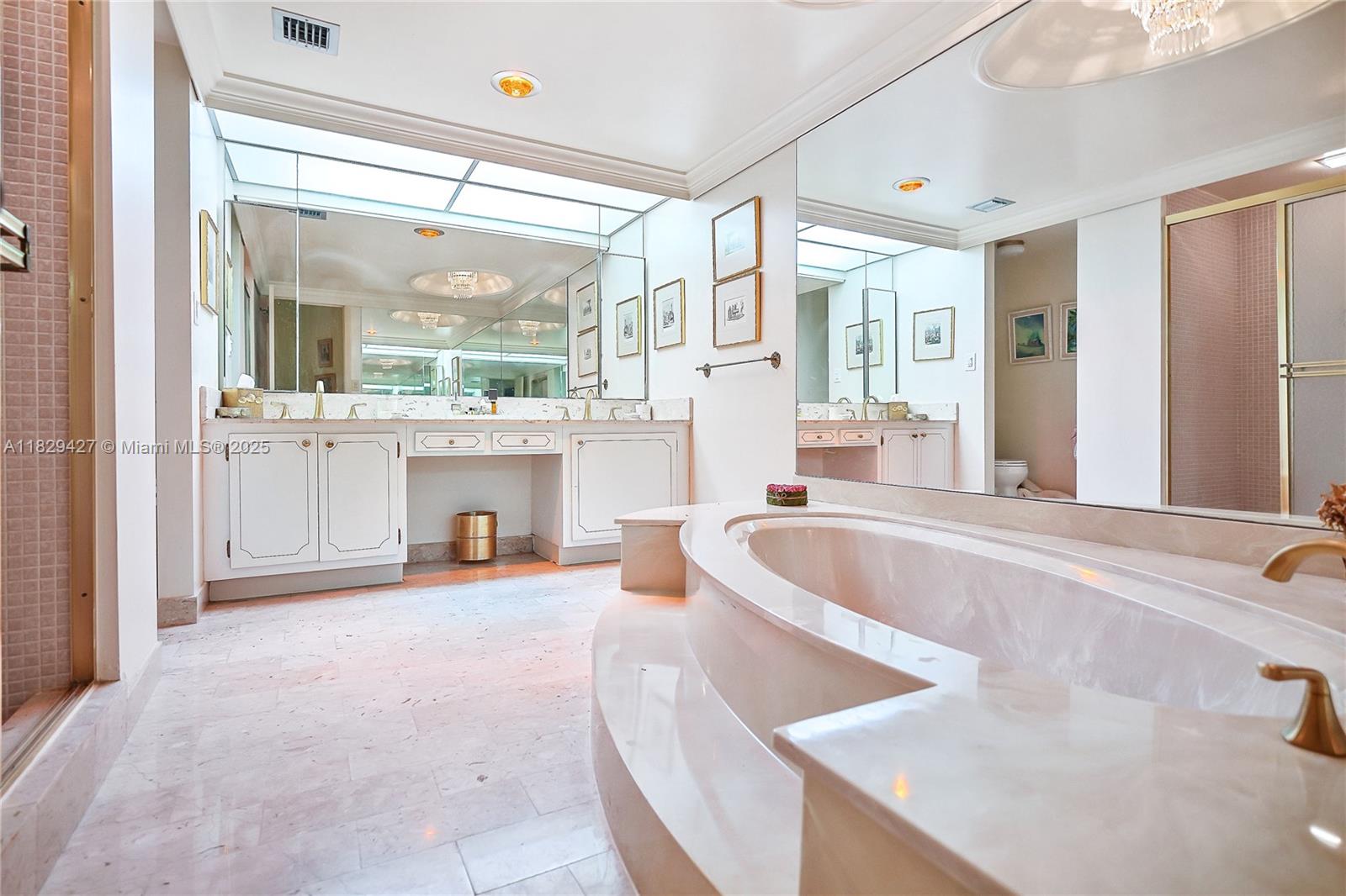 1121 Crandon Boulevard, Unit F201 Key Biscayne, FL 33149 - Photo 36 of 56 a spacious bathroom with a large tub and sink