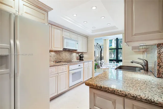 a kitchen with stainless steel appliances granite countertop a sink stove and cabinets