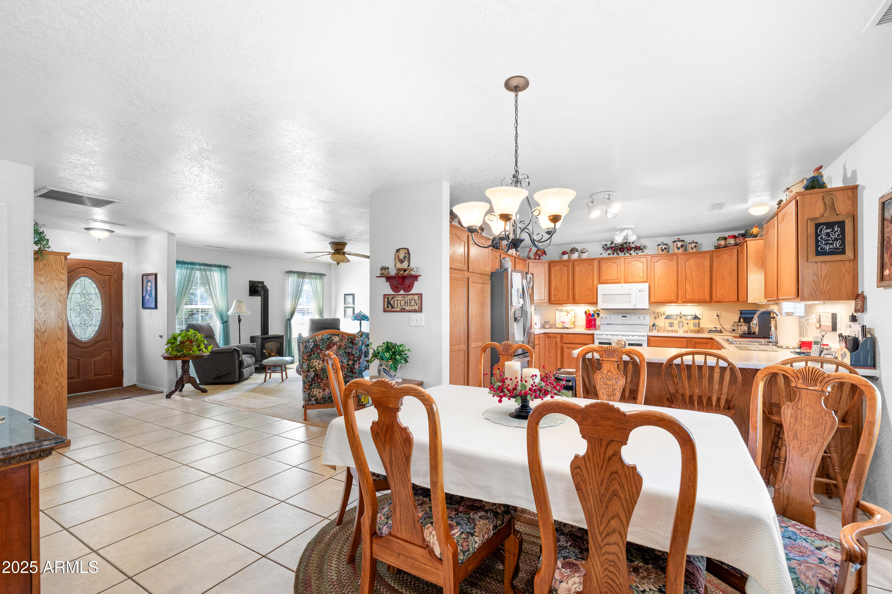 12870 Doyle Road Flagstaff, AZ 86004 - Photo 14 of 49 a view of a dining room and livingroom with furniture wooden floor a chandelier