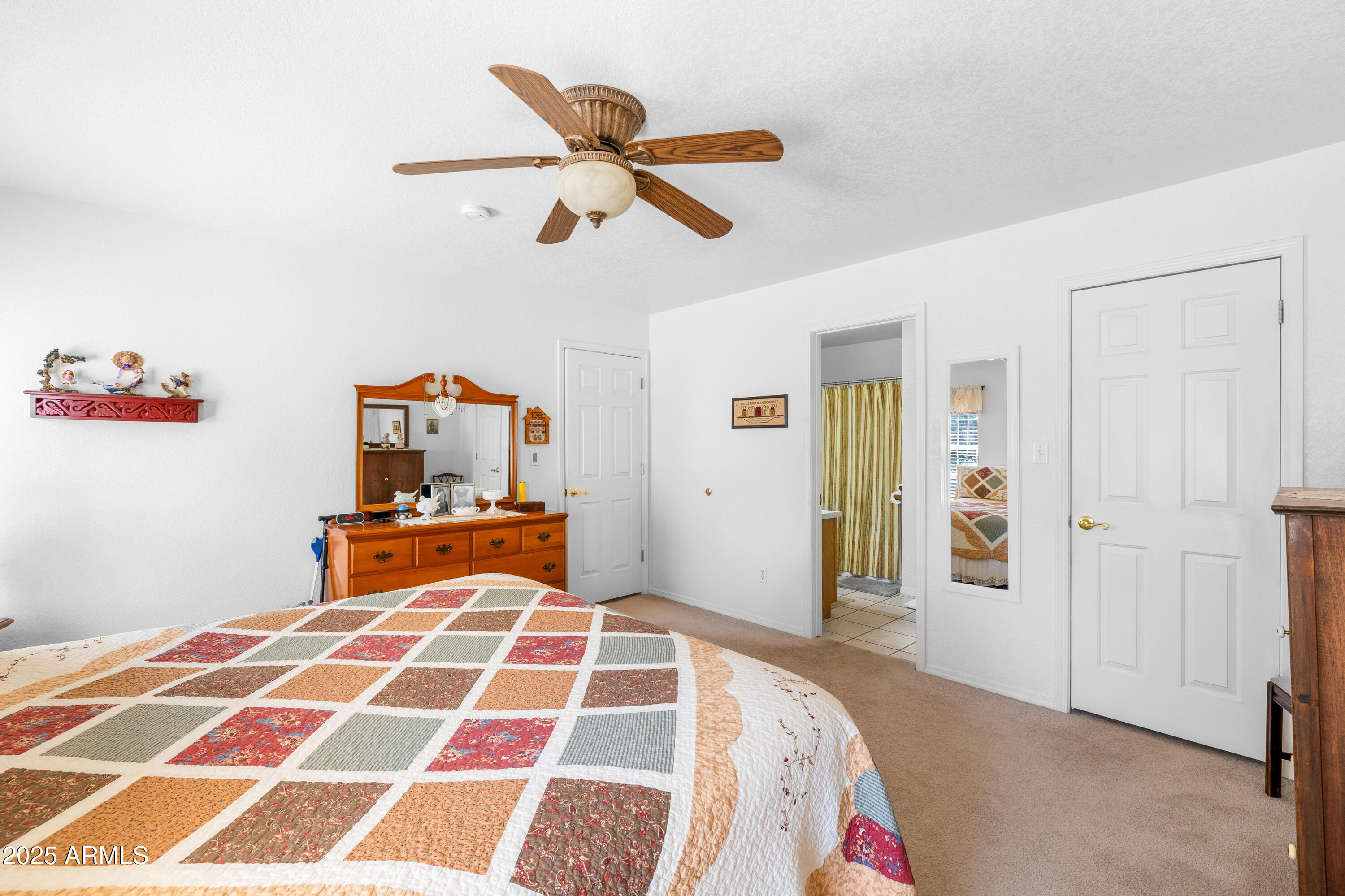 12870 Doyle Road Flagstaff, AZ 86004 - Photo 18 of 49 a bedroom with a bed and a chandelier
