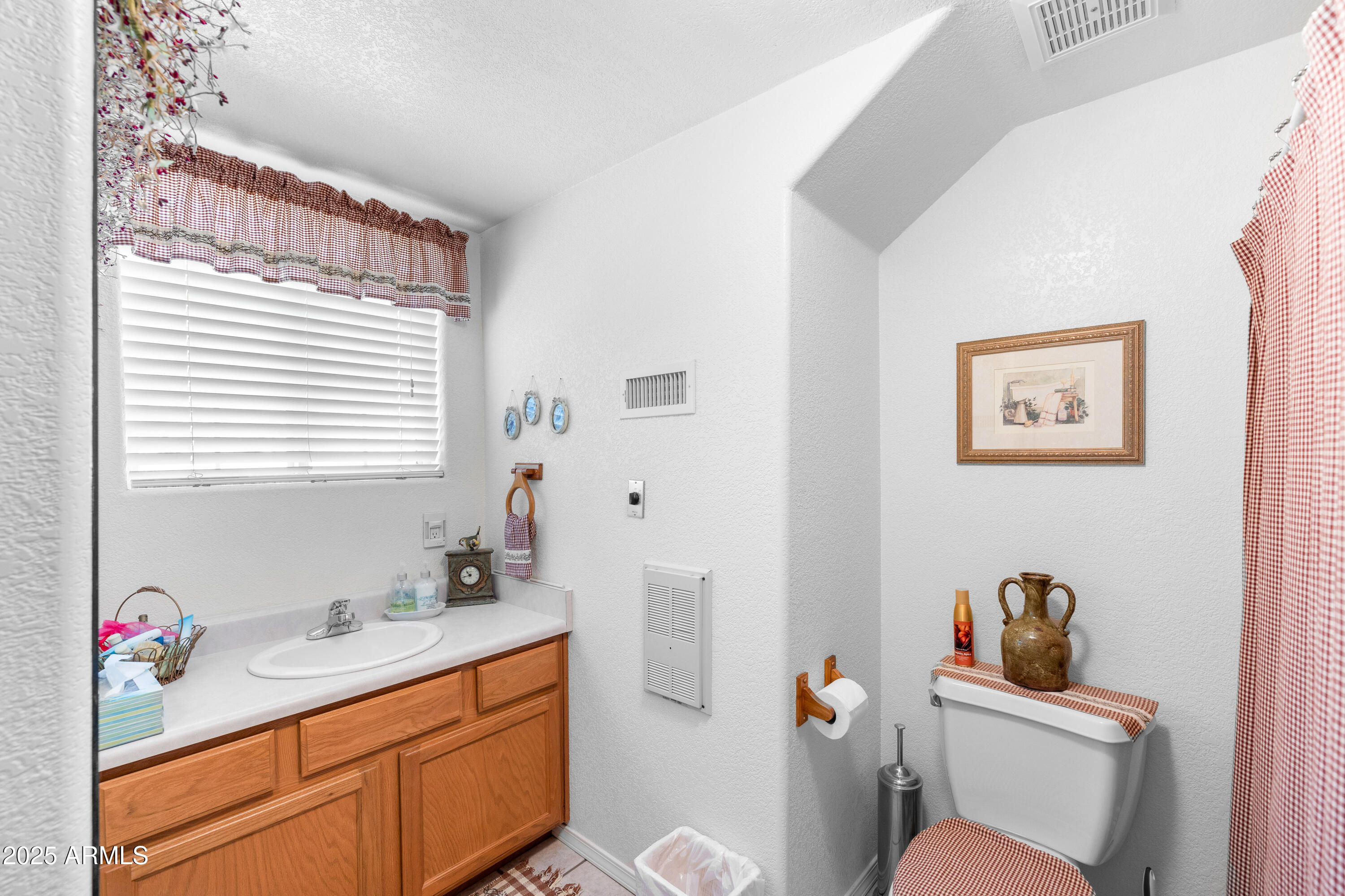 12870 Doyle Road Flagstaff, AZ 86004 - Photo 26 of 49 a bathroom with a sink a mirror a toilet and a window