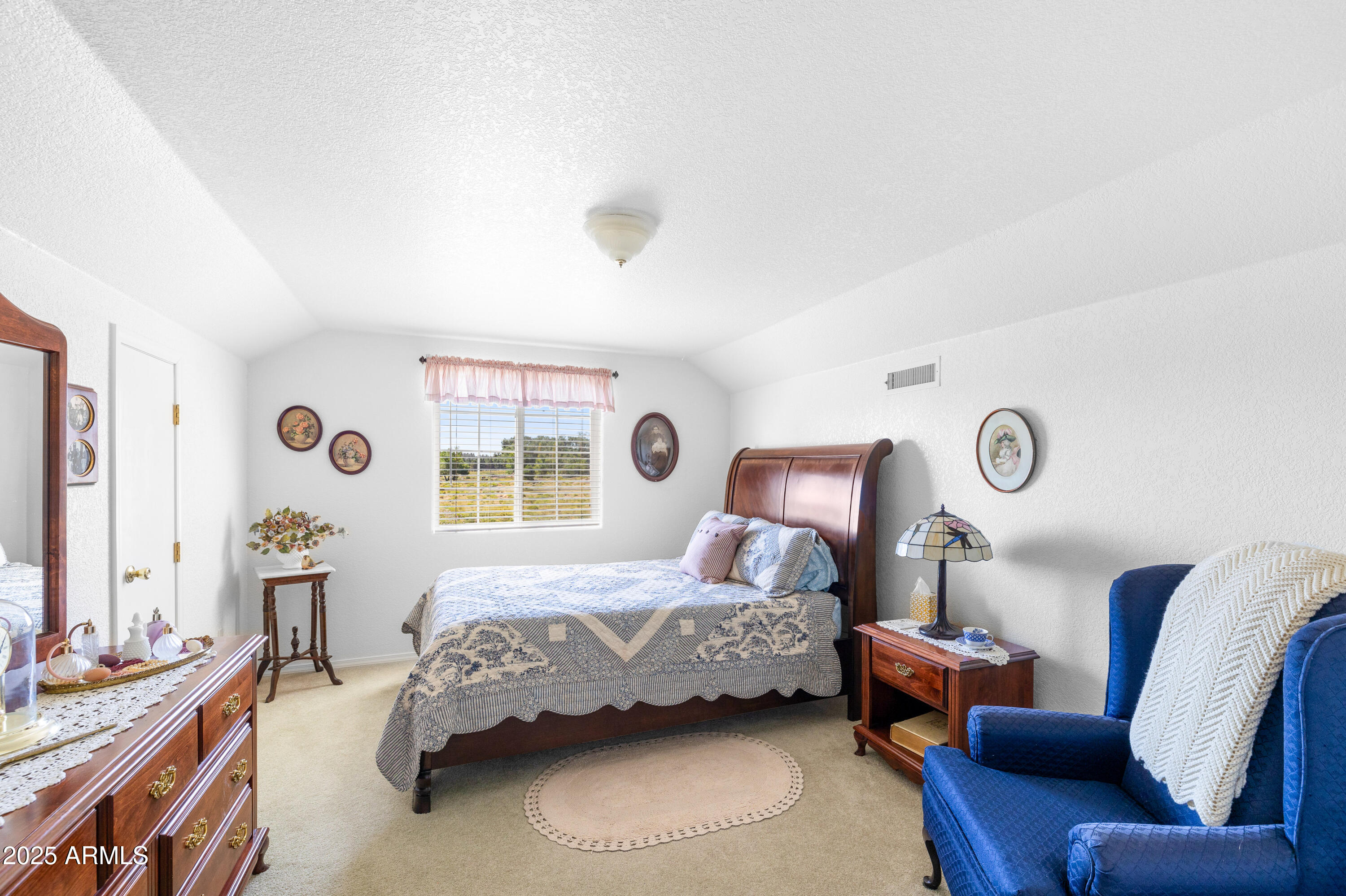 12870 Doyle Road Flagstaff, AZ 86004 - Photo 27 of 49 a bedroom with a bed couch and window