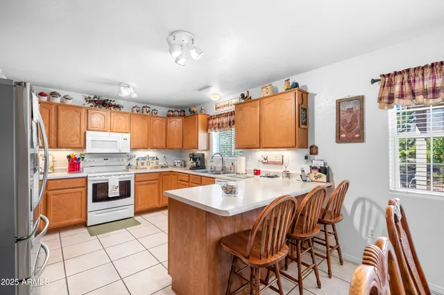 a kitchen with stainless steel appliances a stove a sink dishwasher and cabinets