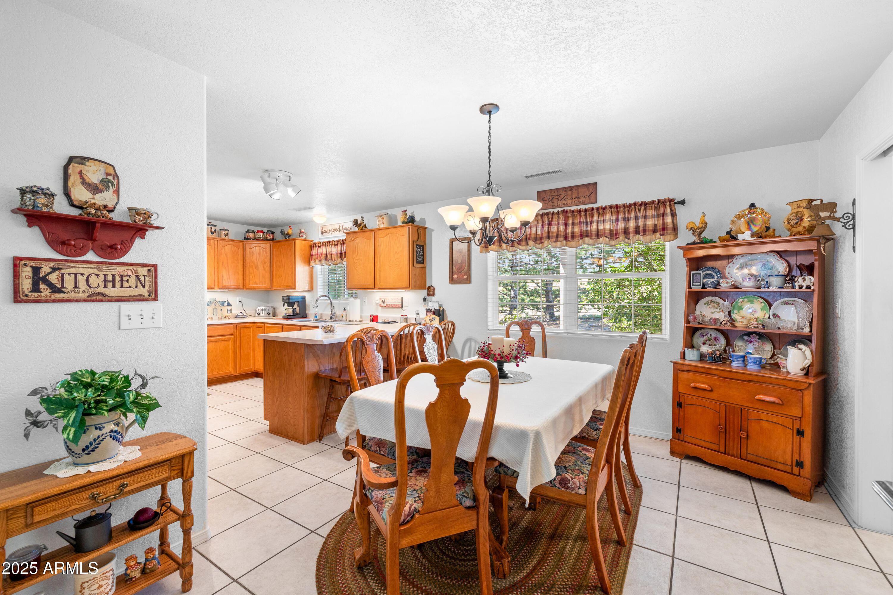 12870 Doyle Road Flagstaff, AZ 86004 - Photo 9 of 49 a view of a dining room and livingroom with furniture wooden floor a chandelier