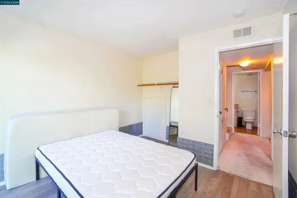 a bathroom with a granite countertop sink mirror vanity and toilet