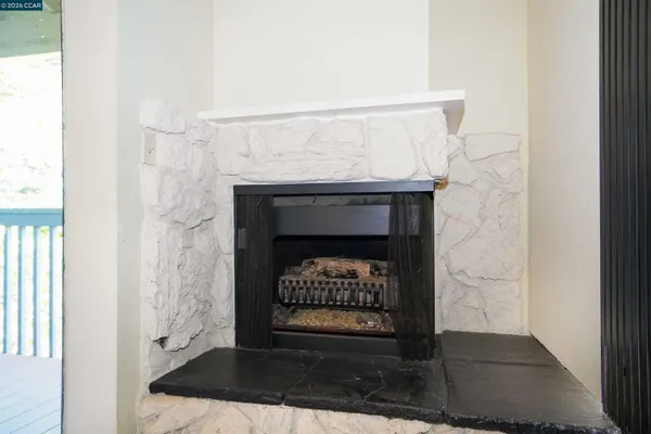 a view of a patio with a table and chairs under an umbrella