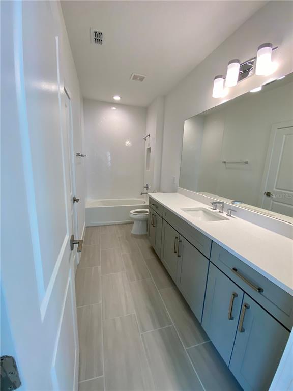 58 Overleaf Lane Orlando, FL 32839 - Photo 29 of 41 a spacious bathroom with a double vanity sink a large mirror and shower