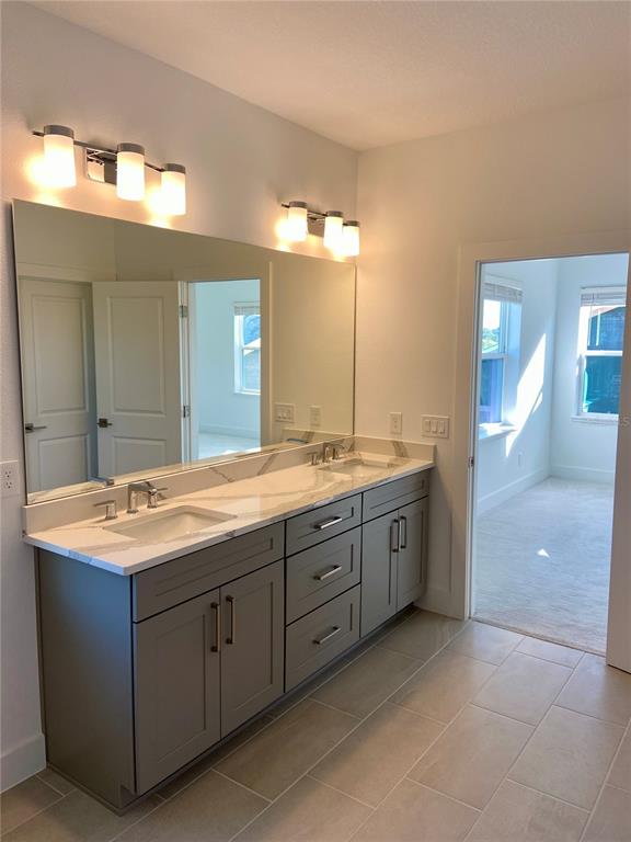 58 Overleaf Lane Orlando, FL 32839 - Photo 8 of 41 a spacious bathroom with a granite countertop sink a mirror and a