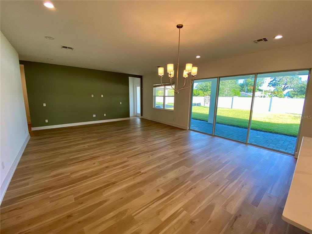58 Overleaf Lane Orlando, FL 32839 - Photo 10 of 41 a view of an empty room with wooden floor and a floor to ceiling window