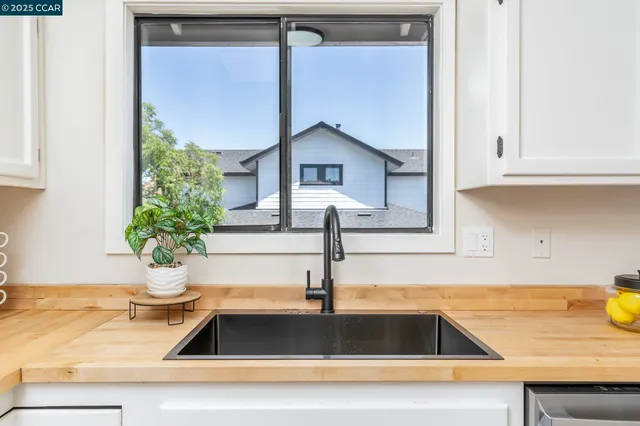 a kitchen with a sink and a mirror
