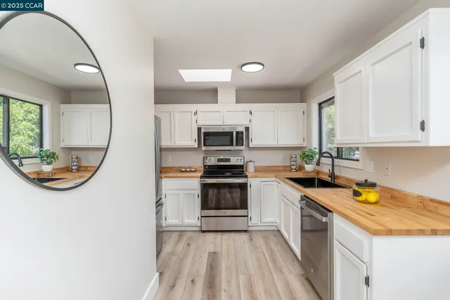 a kitchen with a sink stove and cabinets