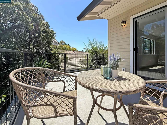 a view of a patio with couches table and chairs and potted plants