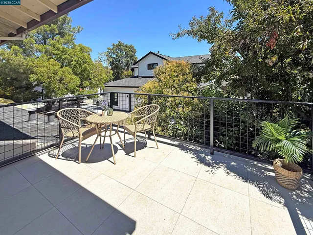a backyard of a house with table and chairs