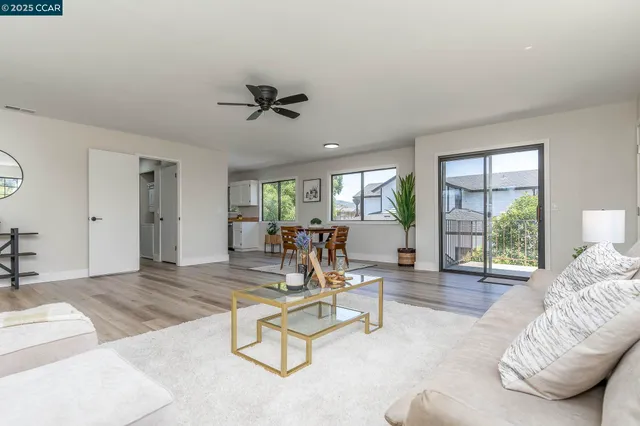 a living room with furniture and floor to ceiling window
