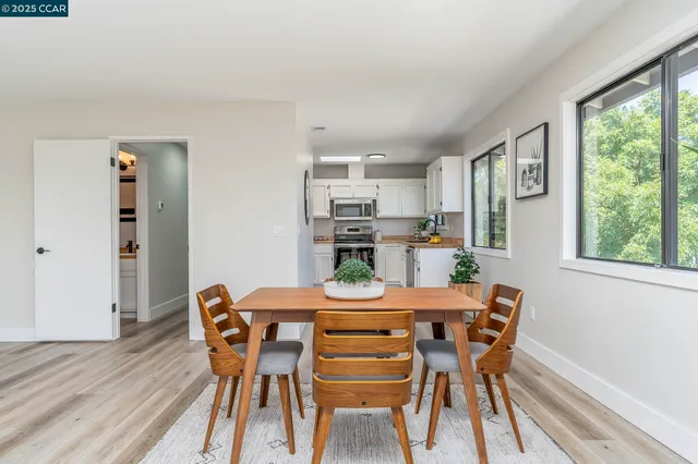 a view of a dining room with furniture window and wooden floor