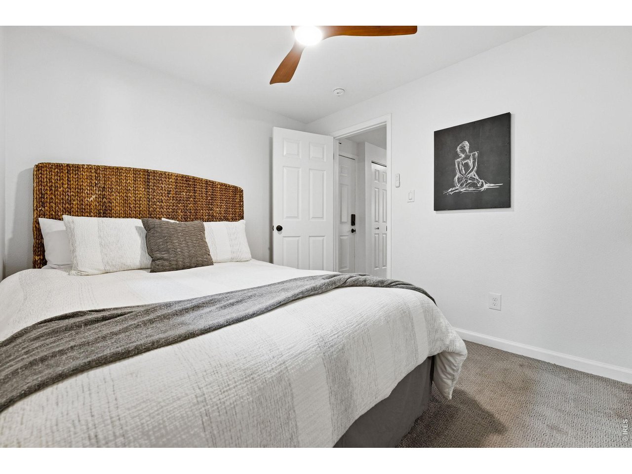 910 Portland Place, Unit 2 Boulder, CO 80304 - Photo 7 of 18 a bedroom with a bed and a painting on the wall