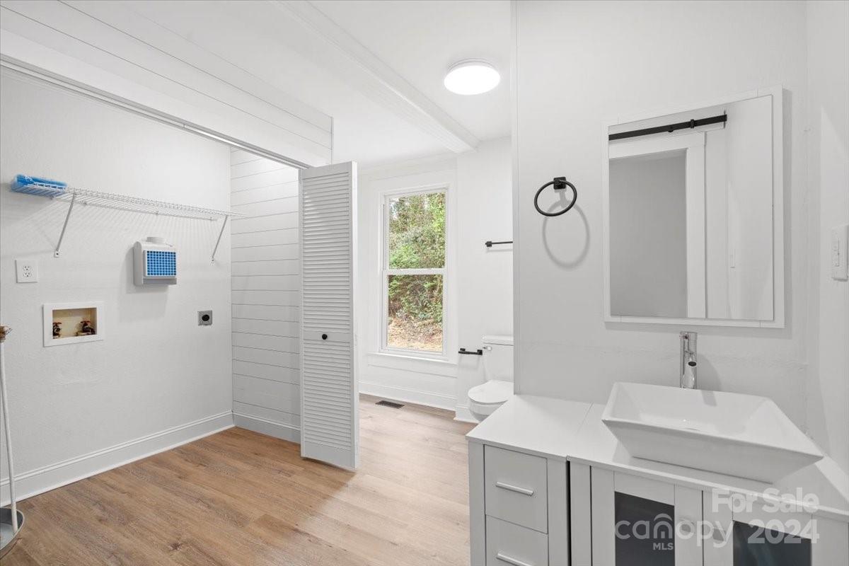 411 West Frederick Street Gaffney, SC 29341 - Photo 12 of 17 a bathroom with a sink a mirror and a shower