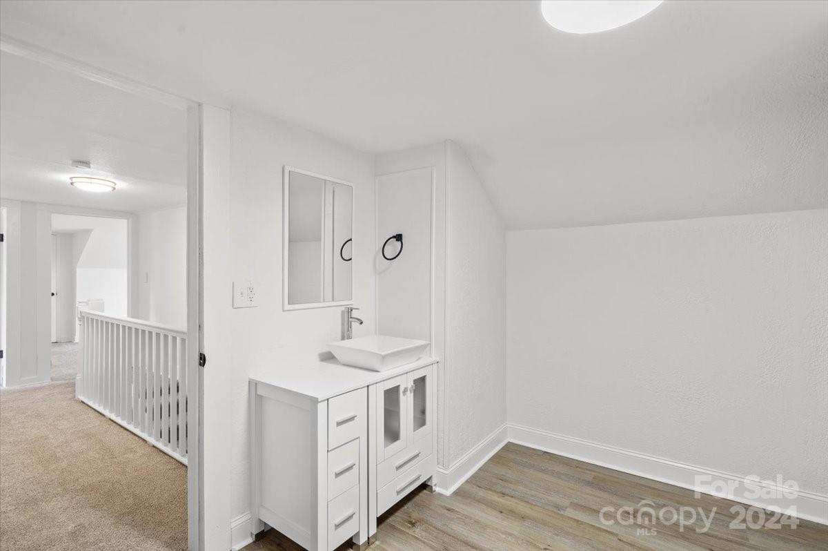 411 West Frederick Street Gaffney, SC 29341 - Photo 14 of 17 a hallway with white cabinets and wooden floor