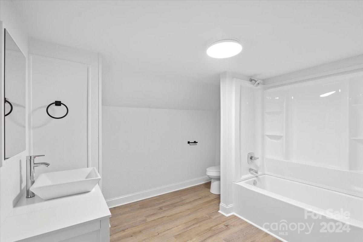 411 West Frederick Street Gaffney, SC 29341 - Photo 15 of 17 a bathroom with a tub sink and a mirror