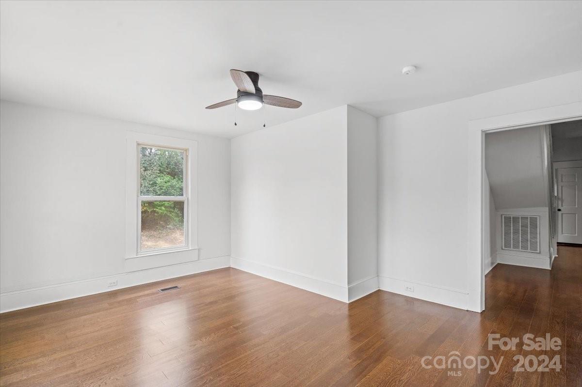 411 West Frederick Street Gaffney, SC 29341 - Photo 3 of 17 a view of an empty room with wooden floor and a window