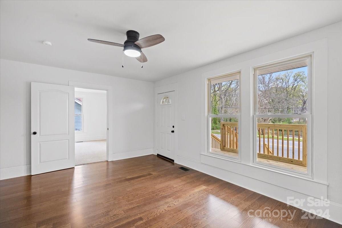 411 West Frederick Street Gaffney, SC 29341 - Photo 4 of 17 a view of an empty room with wooden floor and a window