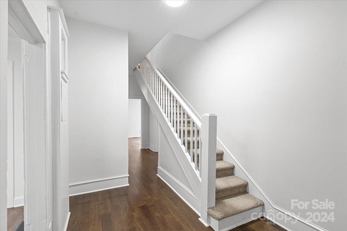 411 West Frederick Street Gaffney, SC 29341 - Photo 5 of 17 a view of staircase with wooden floor and white walls