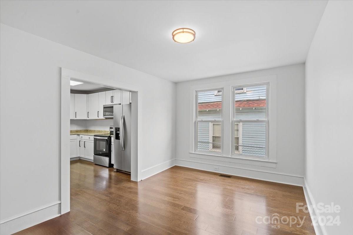 411 West Frederick Street Gaffney, SC 29341 - Photo 6 of 17 a view of empty room with kitchen and window