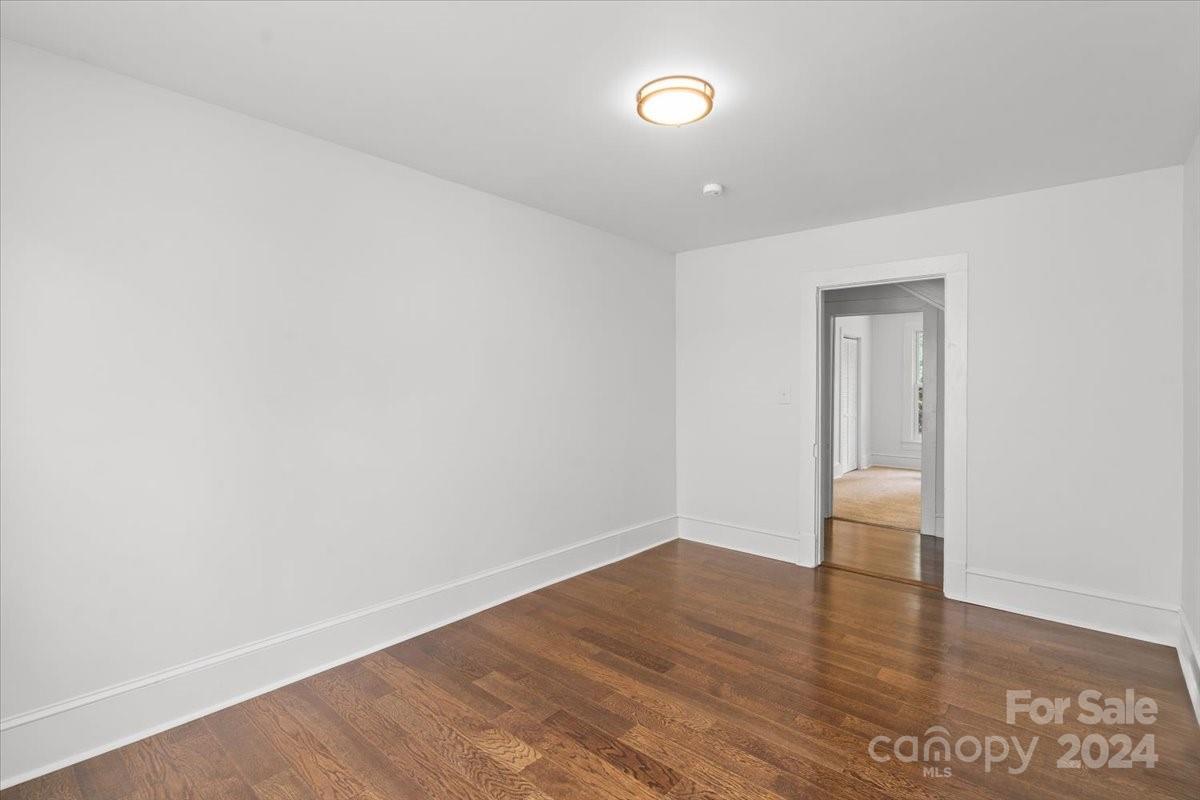 411 West Frederick Street Gaffney, SC 29341 - Photo 7 of 17 a view of an empty room with wooden floor and a window