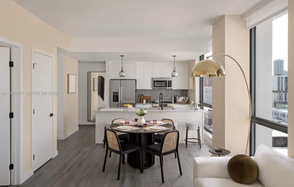 a view of a dining room with furniture and a chandelier