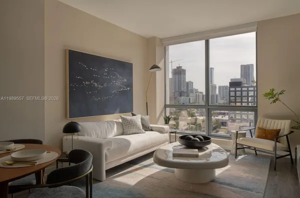 a living room with furniture and a large window