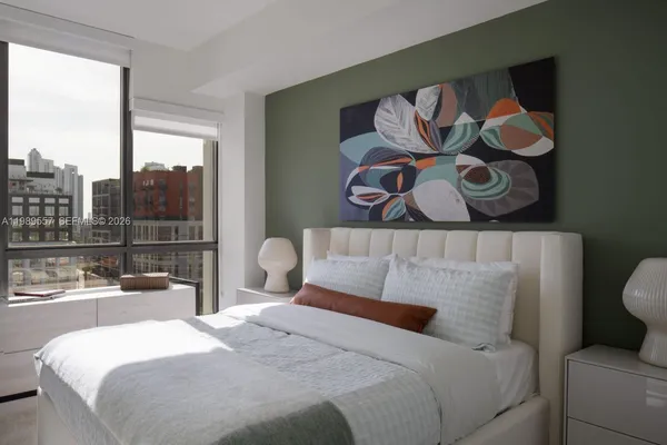 a bedroom with a bed and window