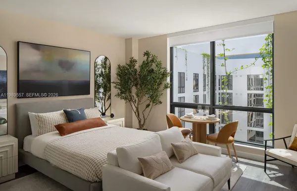 a bedroom with furniture and a flat screen tv