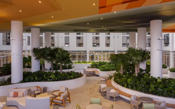 a view of an house with backyard and sitting area