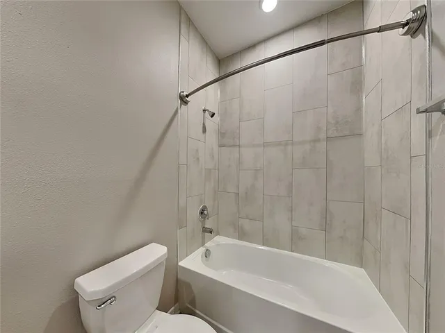 a bathroom with a toilet and bathtub