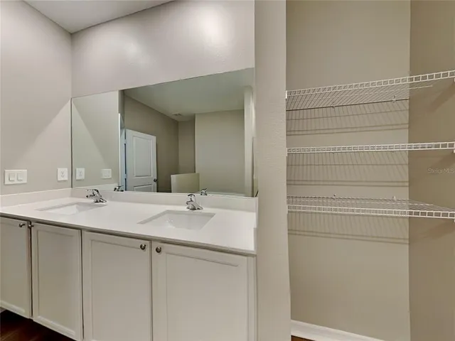 a bathroom with a double vanity sink and a mirror