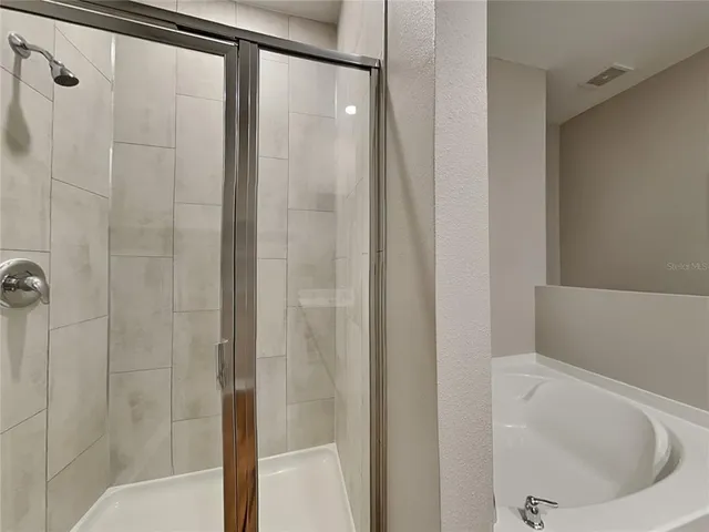 a bathroom with a bathtub and a shower