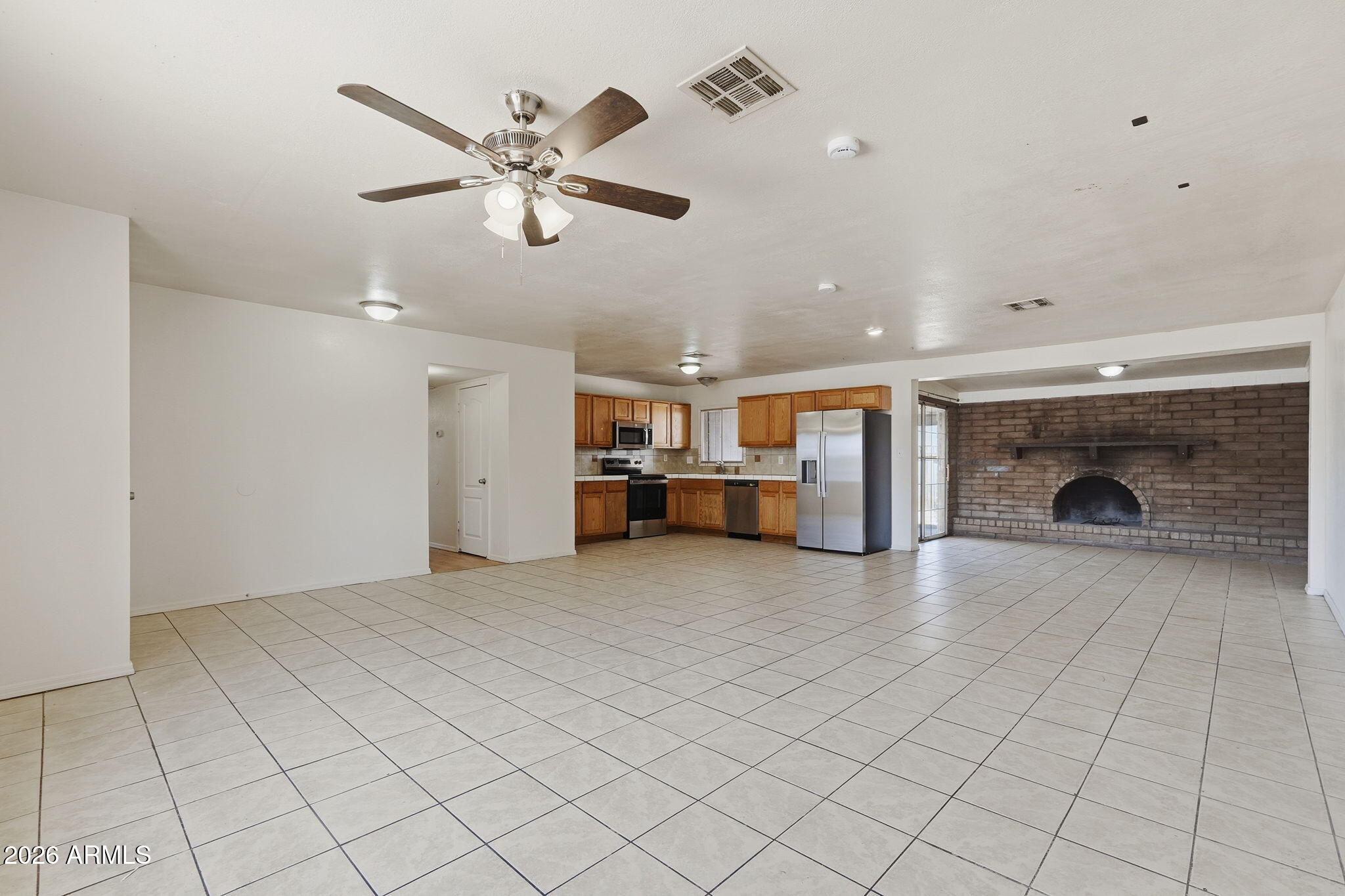 6452 West Thomas Road Phoenix, AZ 85033 - Photo 5 of 30 a view of a livingroom with a ceiling fan a fireplace and a ceiling fan
