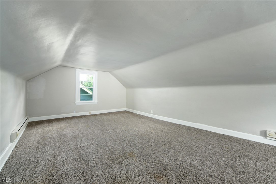 2115 Marlindale Road Cleveland Heights, OH 44118 - Photo 17 of 19 Bonus room featuring dark carpet, a baseboard heating unit, and vaulted ceiling
