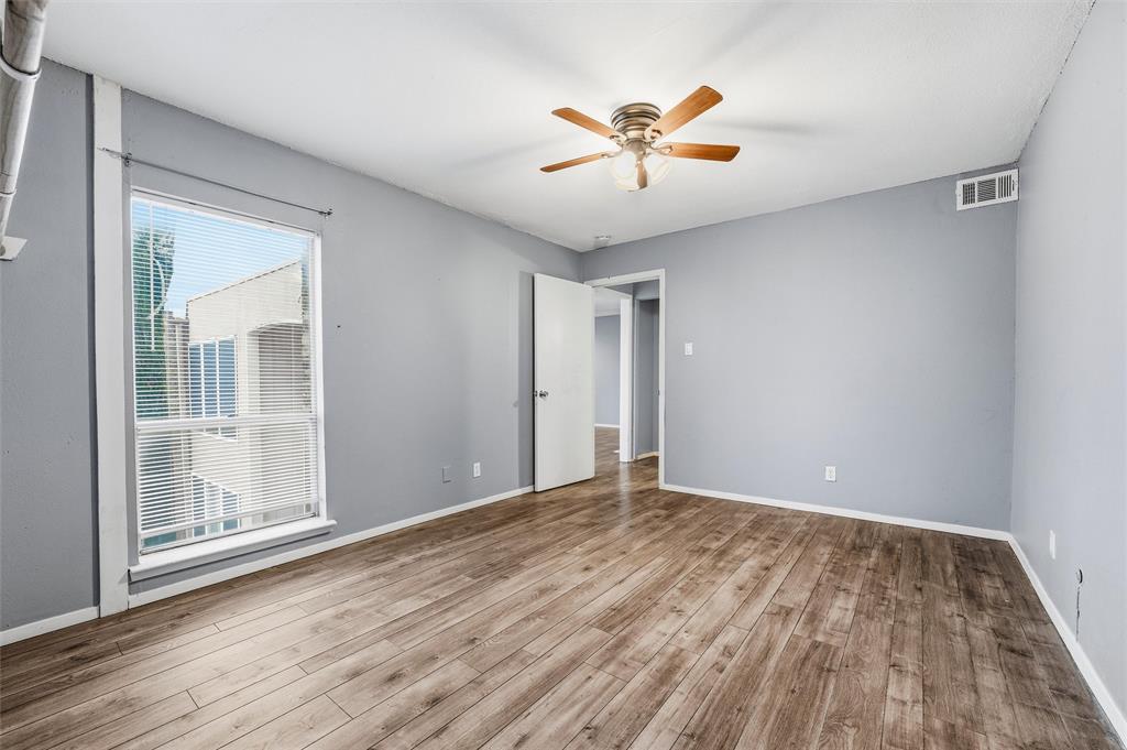 5604 Boca Raton Boulevard, Unit 248 Fort Worth, TX 76112 - Photo 18 of 25 a view of empty room with wooden floor and fan