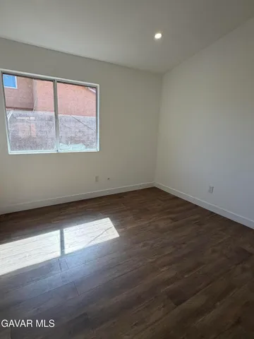 a view of a room with wooden floor and window