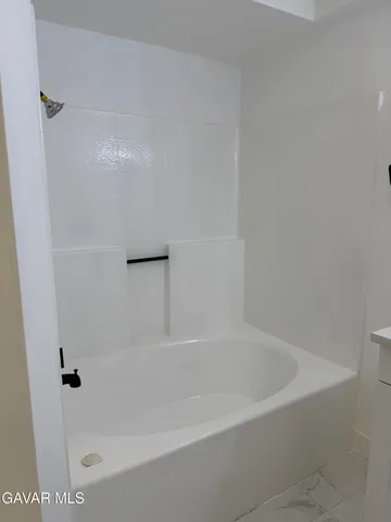 a close up of a bathtub with a shower