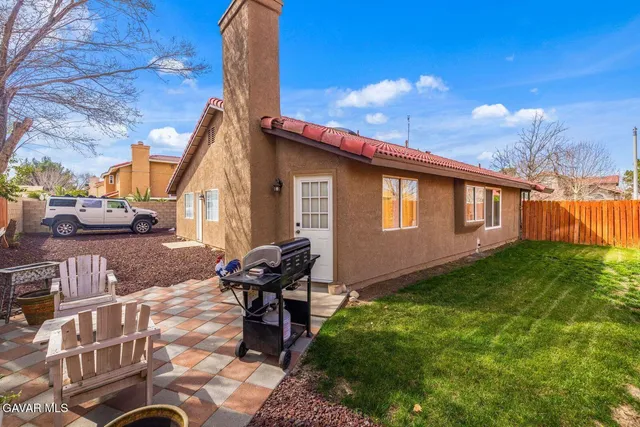 a view of a backyard with sitting area