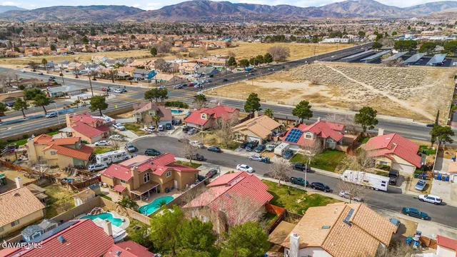 an aerial view of a houses with a lake