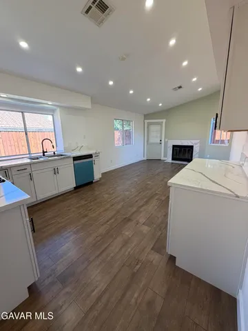 a view of kitchen and hall with wooden floor