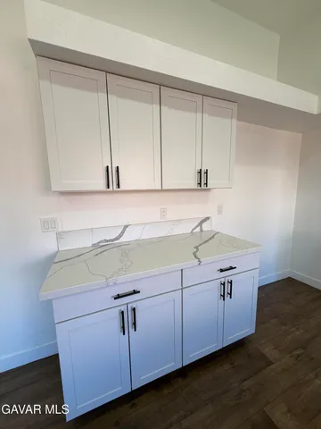 a bathroom with a sink and cabinets