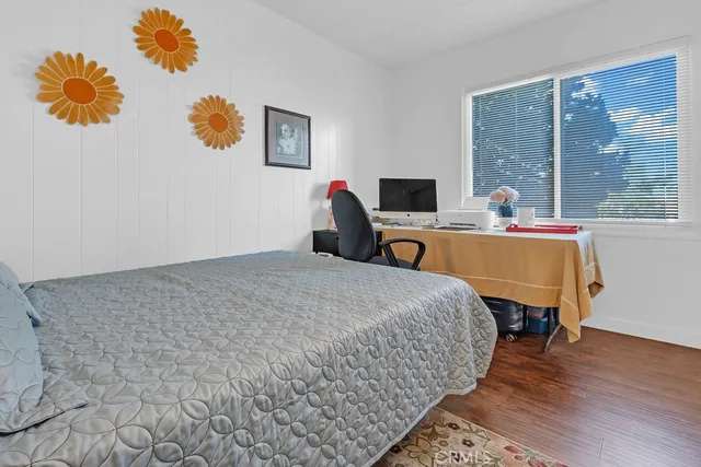 a bed room with a bed and a chair