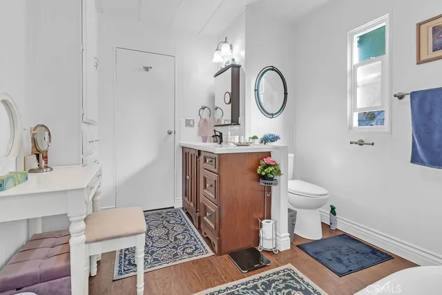 a bathroom with a toilet a sink and a mirror