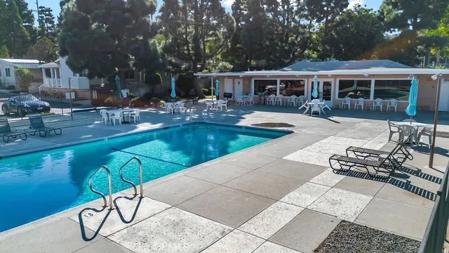 a view of a swimming pool with outdoor seating