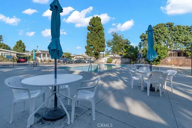 a view of a patio with table and chairs and potted plants